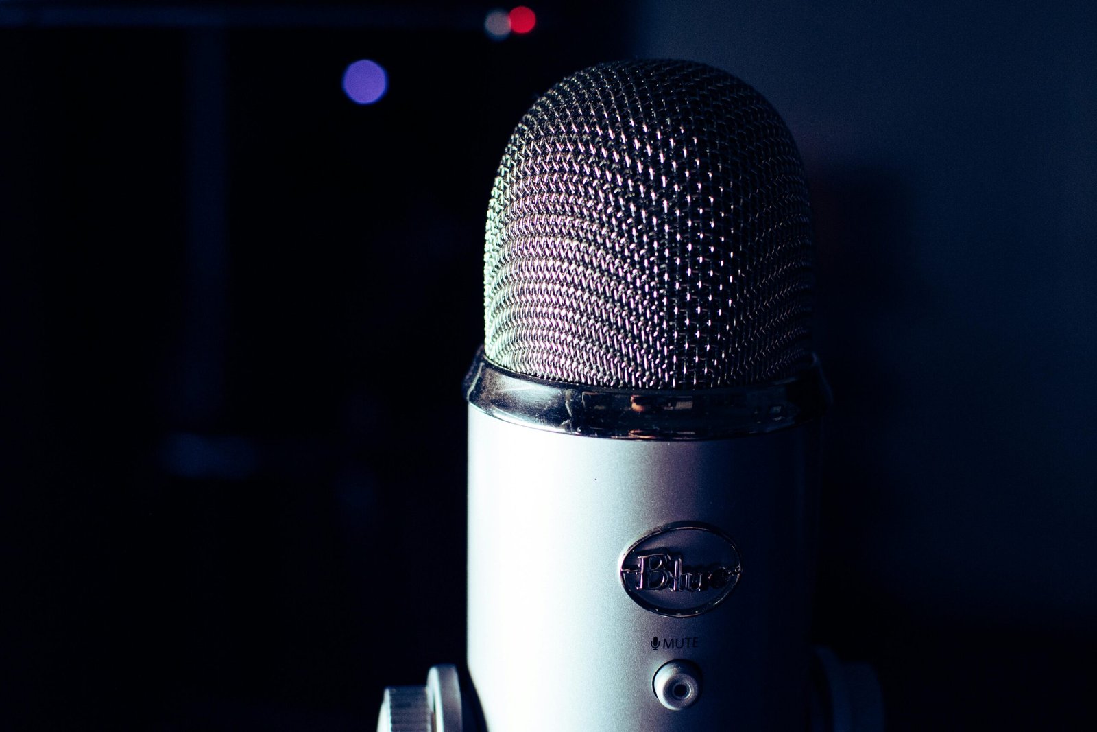 Dynamic photo of a condenser microphone in a dimly lit studio, perfect for podcasts.